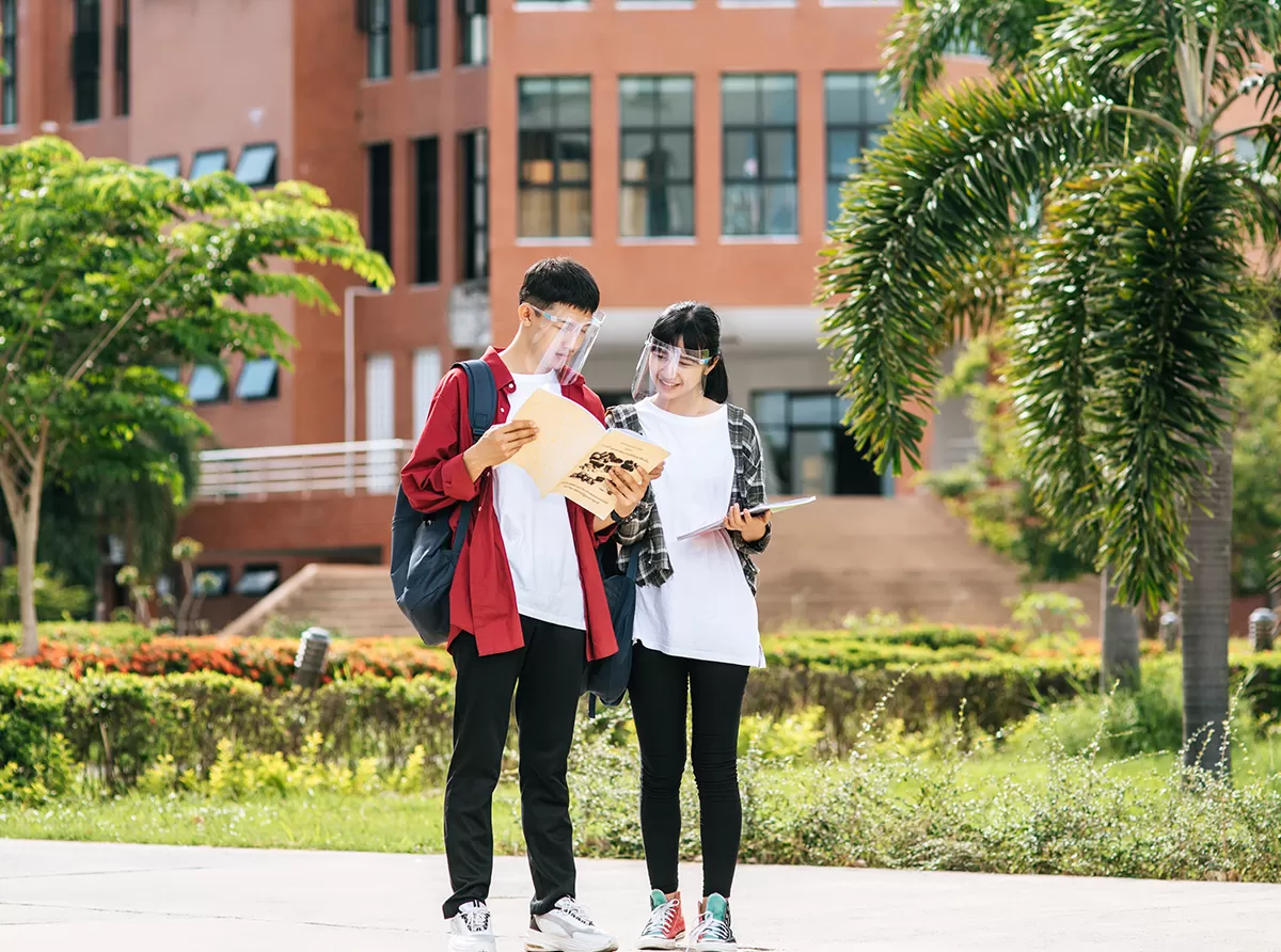 Study in Singapore – Best Universities & Career Opportunities Two students walking inside a university campus, exploring academic opportunities in a global education hub.