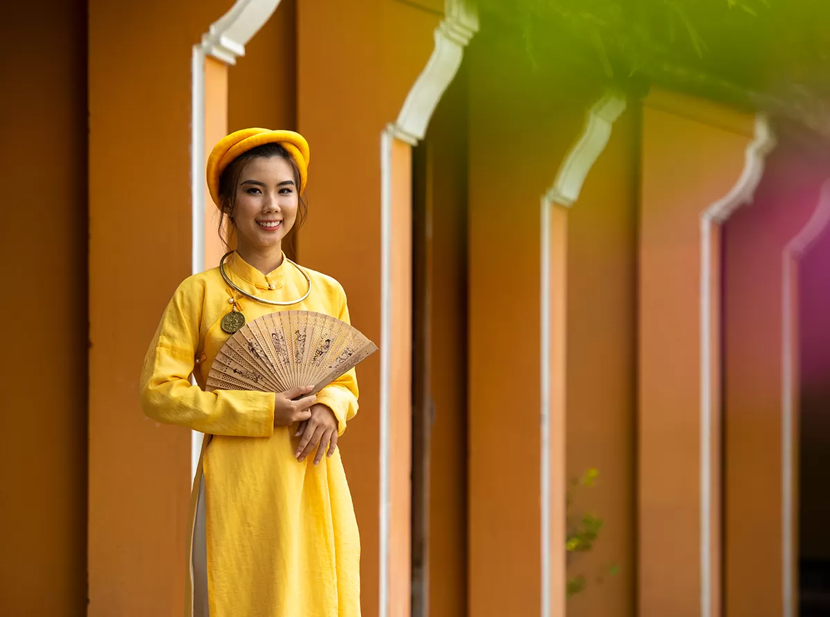 Study in Vietnam – Top Universities & Admission Process A student wearing traditional clothing inside a university campus, celebrating culture and education.